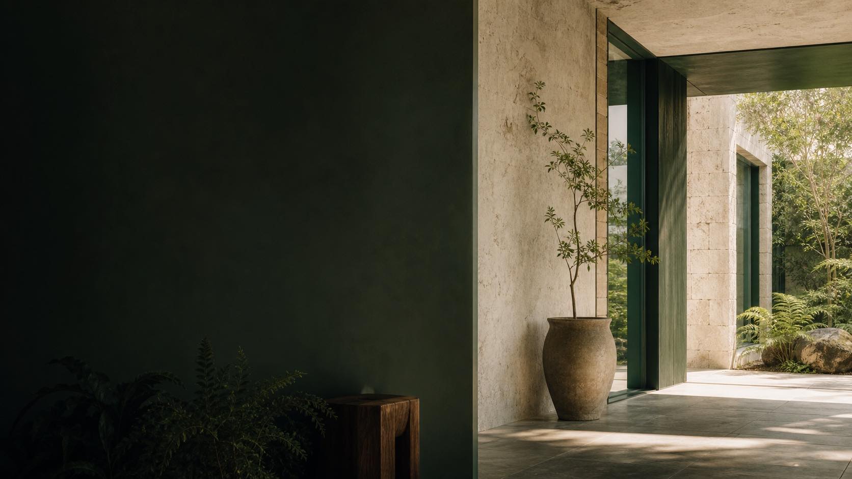 A calm, light-filled architectural space framed by greenery